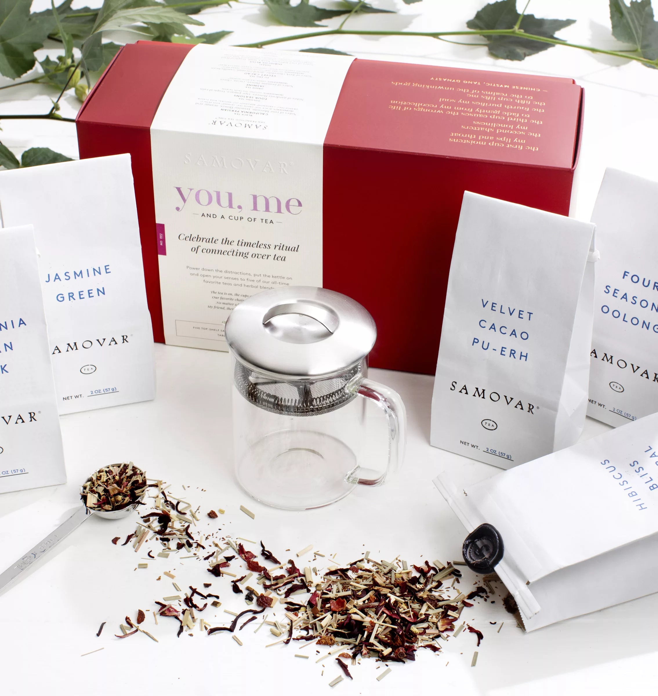 An organic tea gift set featuring a box containing tea, tea bags, and a teapot.