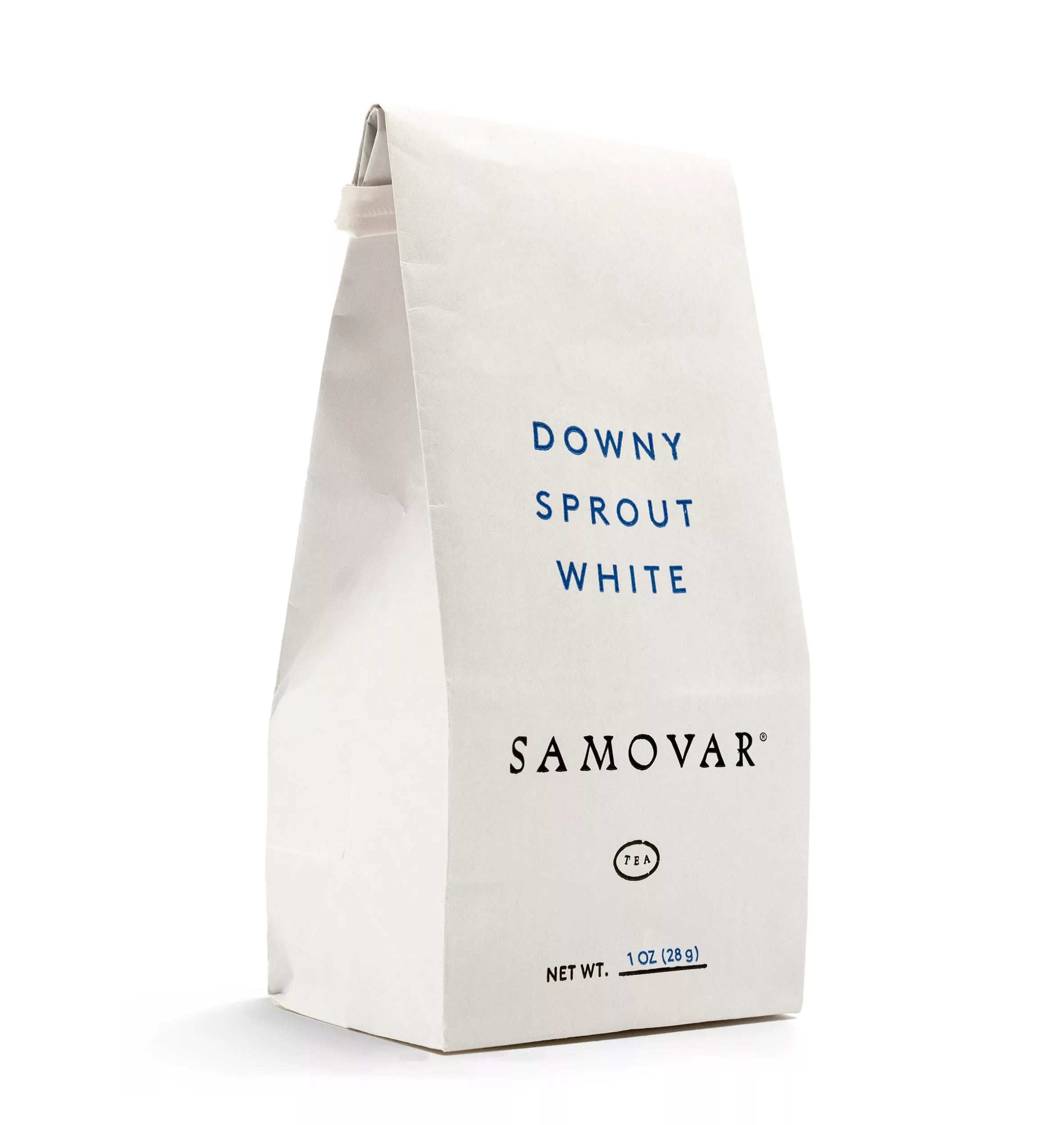 A downy sprout tea bag placed next to a decorative samovar, showcasing its white color and delicate design.