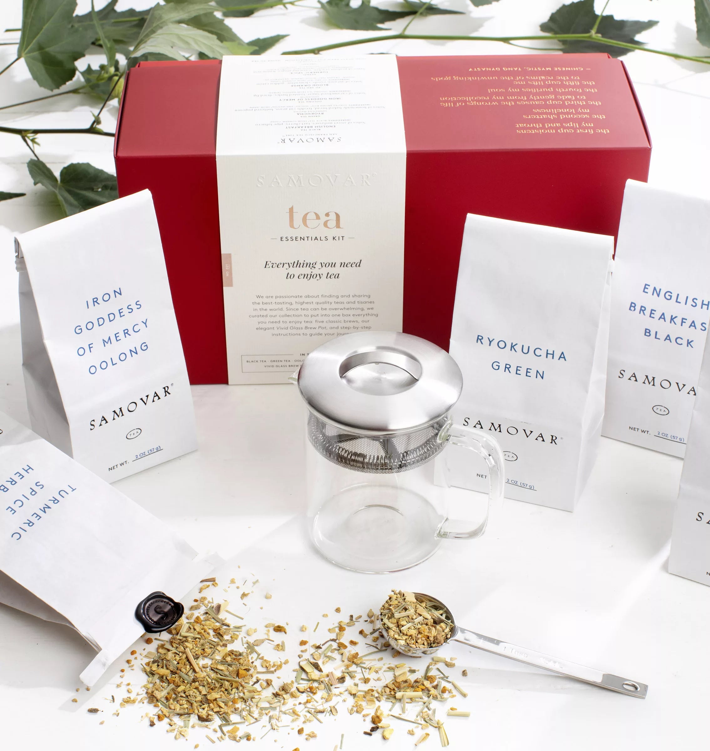 A tea box showcasing tea bags and a teapot, included in a tea and mug set kit.