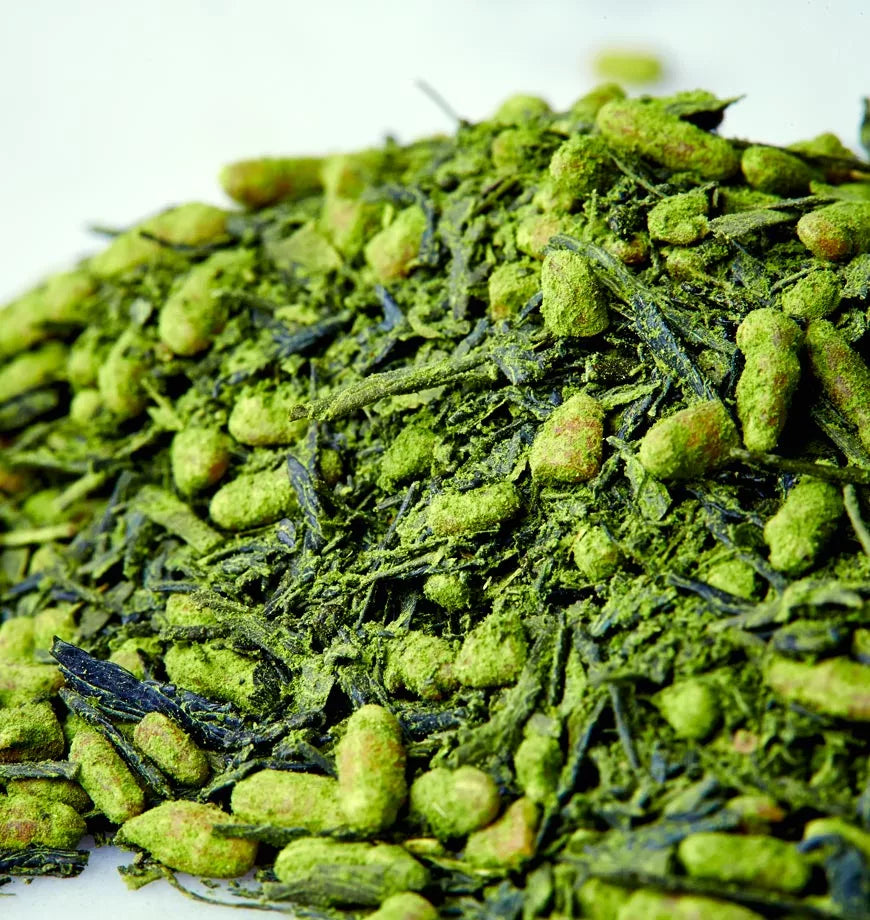 Organic Ryokucha green tea leaves arranged in a pile on a white background