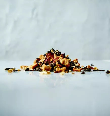 A colorful assortment of dried fruit and nuts, including apple ginseng, arranged on a white surface.