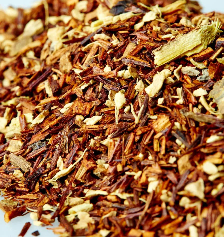 A pile of dried Rooibos tea leaves labeled Ocean of Wisdom on a white surface.