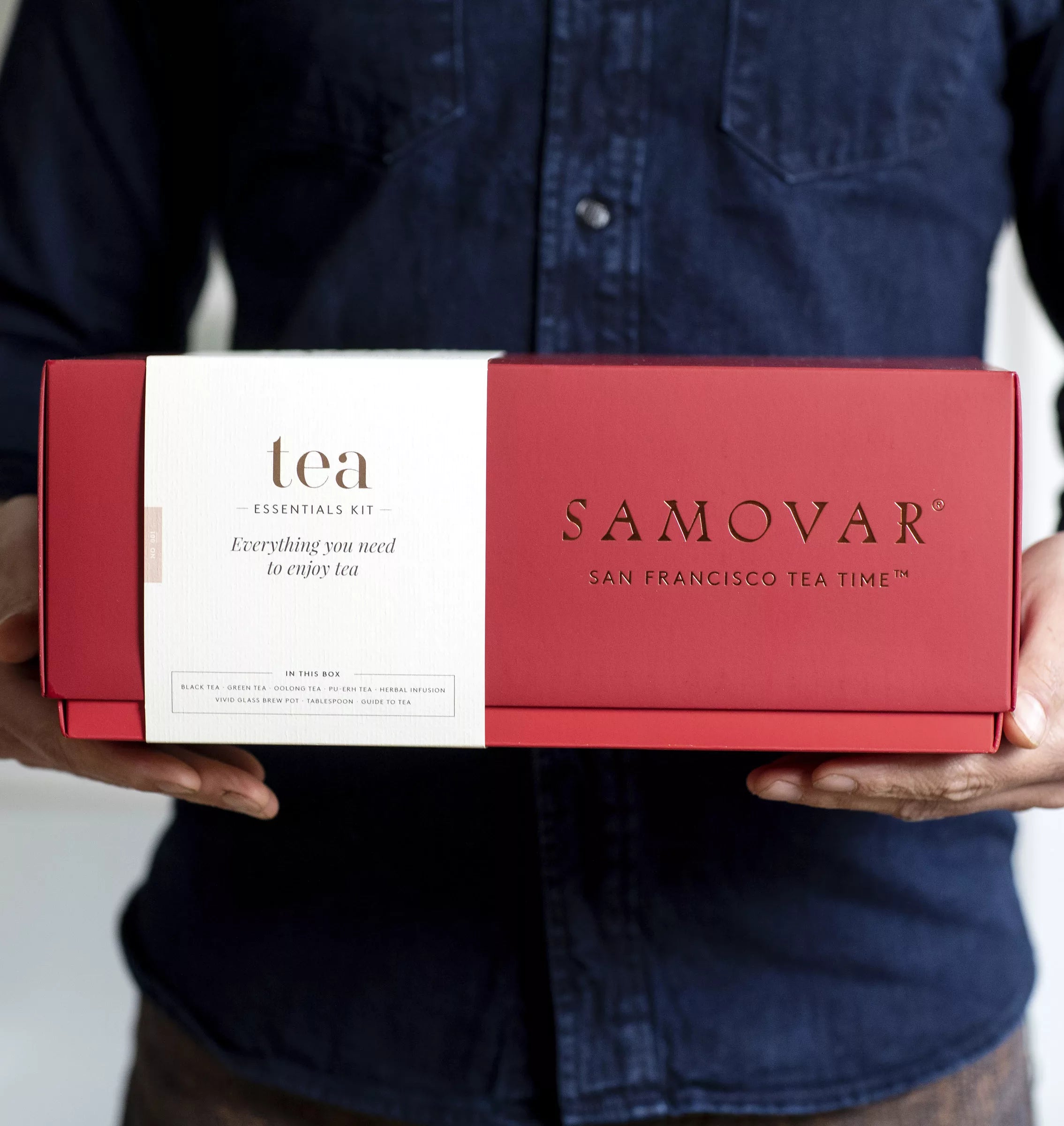 A decorative samovar tea box displayed alongside a matching tea and mug set.
