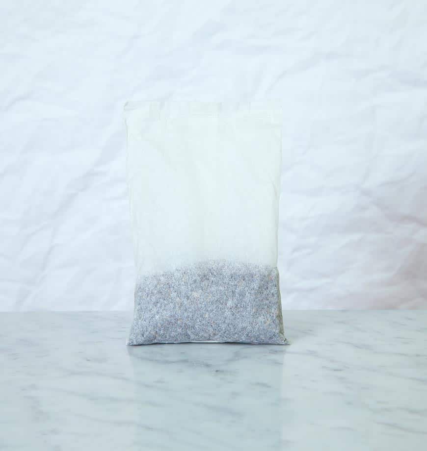A bag of lavender sits on a table next to a pouch labeled Black Iced Tea.